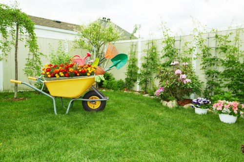 Gardener wearing PPE and using a hedge trimmer